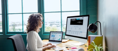 A woman wearing glasses looking at the screen