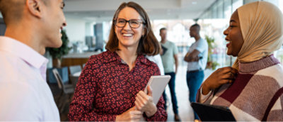 A woman smiling with a tablet.