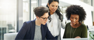 A group of people looking at a computer screen.