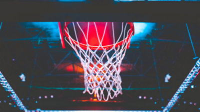 A close-up of a red and white basketball hoop with a net.