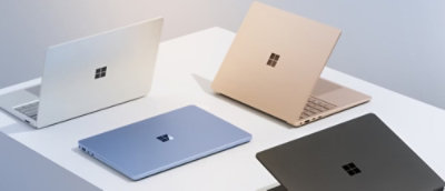 Multiple laptops arranged in a semi‑circle on a flat surface.