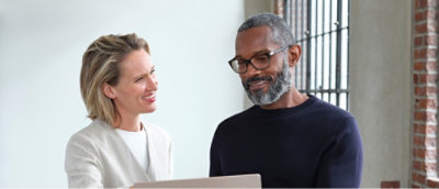 A man with glasses and a woman looking at each other.