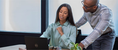 A man and woman collaborate on a laptop, sharing ideas and working together in a focused environment.