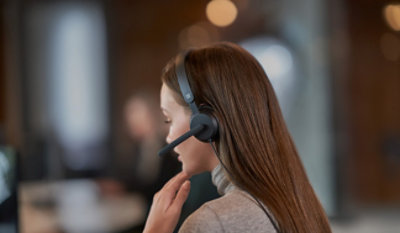 An employee taking on headphone.