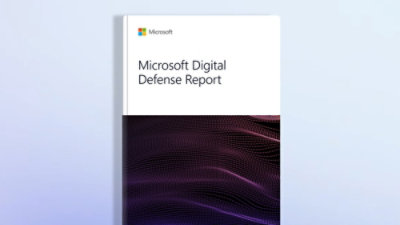 A close-up of a book with text that reads Microsoft Digital Defense Report against a purple and black background.