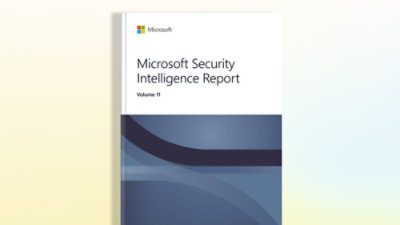 A close-up of a book with a white and blue cover featuring the text Microsoft Security Intelligence Report Volume 11.