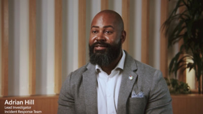A man with a beard wearing a suit, accompanied by text that reads Adrian Hill, Lead Investigator, Incident Response Team.