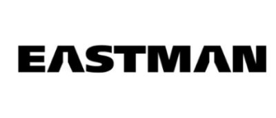 A large building with glass windows against a blue sky.