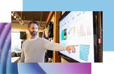A men pointing at a large screen and explaining.