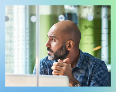 A close-up of a bearded man's face.