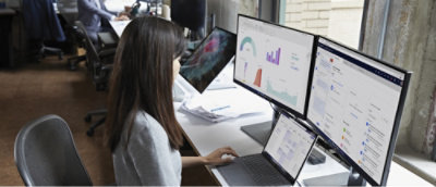 A woman with long hair using a computer.