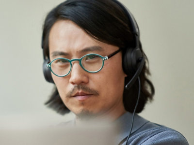 A man looking into laptop screen.
