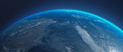 View of Earth from space with clouds and blue atmosphere.