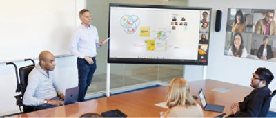 A man and woman standing in front of a screen.