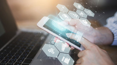 A woman holding a phone in a warehouse.