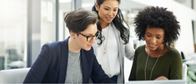 A group of women looking at a computer.