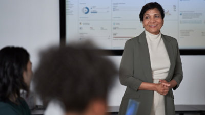 Person presenting to team in meeting room