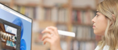 A woman holding a Marker and looking into computer screen