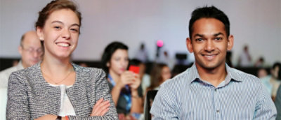 A woman and a man sitting together and smiling