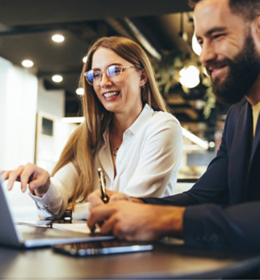 A woman and man discussing while looking at the laptop