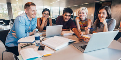 group of people discussing while looking at the laptop