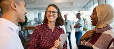 A woman smiling with glasses.