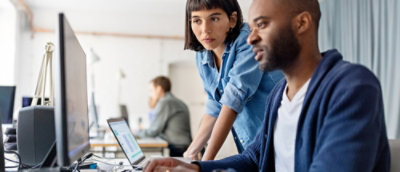 A man and a woman looking at a laptop together.