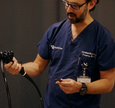 A doctor holding a instrument on his hand