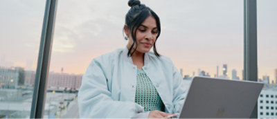 A person in a white jacket using a computer
