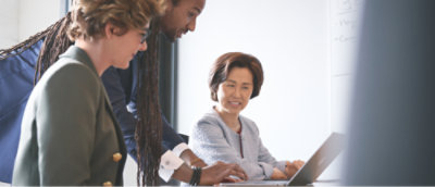 A group of people looking at a computer