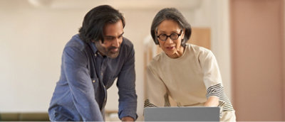 A man and woman looking at a laptop