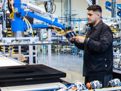 A man holding a blue and black machine.
