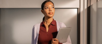 A women holding a laptop.