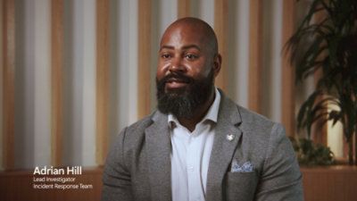 A man with a beard wearing a suit, accompanied by text that reads Adrian Hill, Lead Investigator, Incident Response Team.