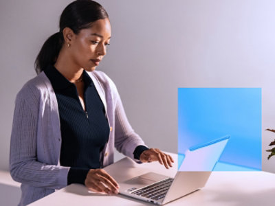 A person sitting at a desk using a laptop.