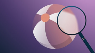 A close-up of a purple and white beach ball with a magnifying glass highlighting a segment on a purple background.