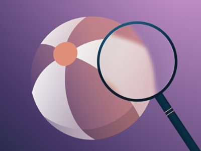 A close-up of a purple and white beach ball with a magnifying glass highlighting a segment on a purple background.