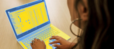 A close-up of a hand on a keyboard.