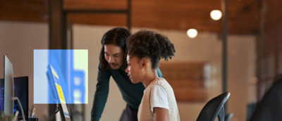 A man and a woman looking at a computer screen.
