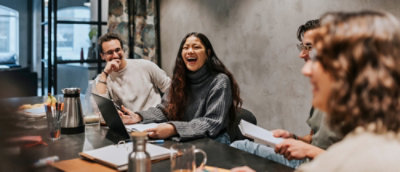 A group of people sitting at a table laughing.