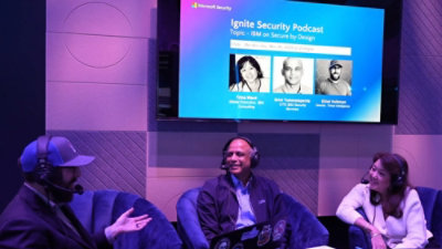 A woman and two men sitting in chairs.