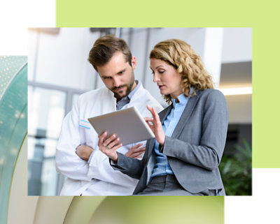 Two people discussing while looking at the tablet