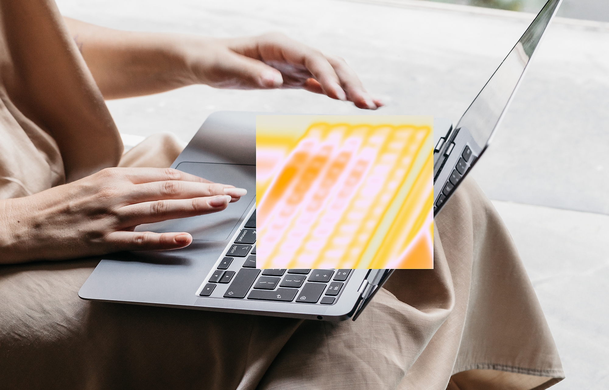 A person typing on a laptop.