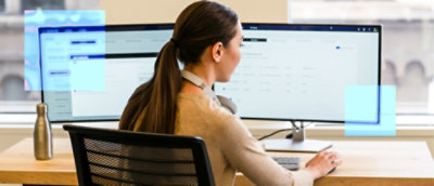 A woman sitting at a desk using a computer.