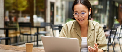 A woman looking at a laptop.