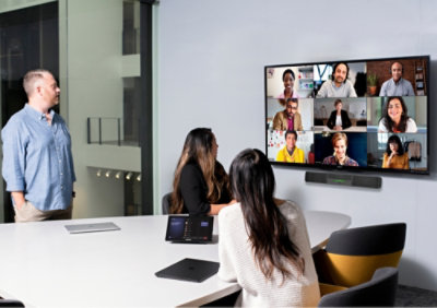 Three people in an office setting: one takes notes, another types on a keyboard