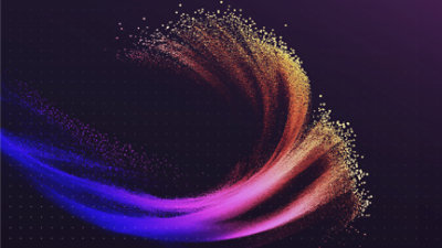 A sphere made of numerous small particles in pink and yellow hues is dispersed against a dark background.