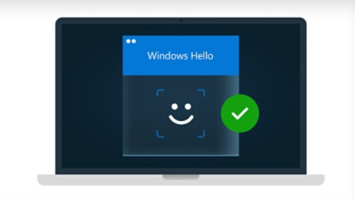 A computer screen displaying a blue background with a white smiling face and a check mark, accompanied by the text Windows Hello.