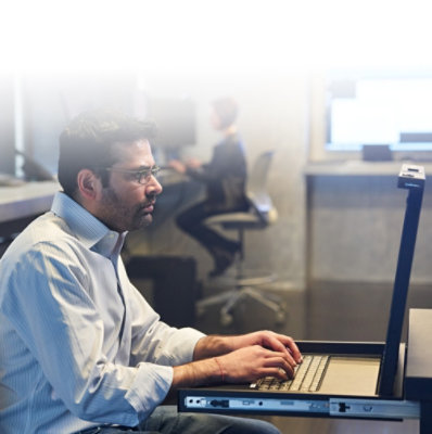 Person working on a laptop in a modern office setting