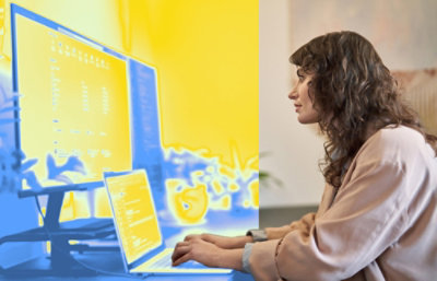 A person sitting at a desk using a laptop.